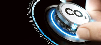 Man turning a carbon dioxyde knob to reduce emissions  CO2 reduction or removal concept  Composite image between a hand photography and a 3D background 