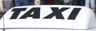 Closeup of taxi cab sign in city centre