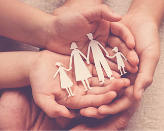 Adult and children hands holding paper family cutout  family home  foster care  homeless support concept 